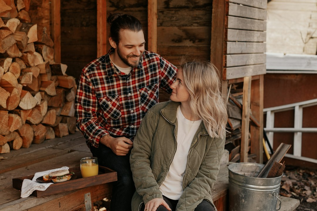 Two people relaxing outside a cabin